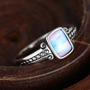 Macro shot of vintage silver ring featuring rectangle opal stone with ornate engraving
