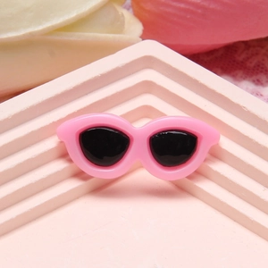 Close-up of pink mini resin sunglasses accessory for DIY crafts and dollhouse models