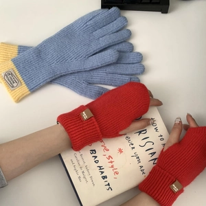 Detail of blue and red knit gloves featuring touch screen compatibility and thick thermal yarn