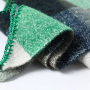 Close-up of soft cashmere-like color block scarf showing wool texture and stitched edges