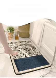 Detail of plush floral bath mat with non-slip backing in a cozy bathroom setting