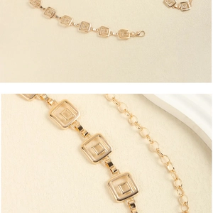 Close-up of golden geometric square link waist chain with adjustable lobster clasp