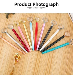 Close-up of assorted heart crystal metal ballpoint pens in various metallic colors