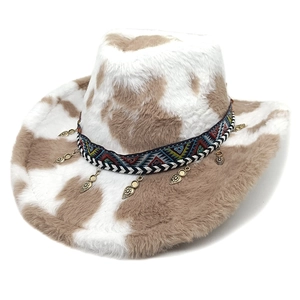 Detail of cow print faux fur cowboy hat with ethnic style woven band and metal charms