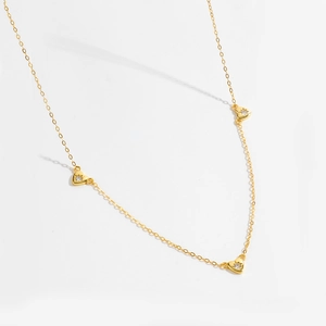 Elegant gold S925 sterling silver necklace with three zircon heart pendants on white background