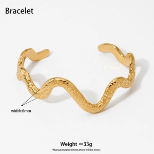 Polished wavy stainless steel bangle with hammered texture and golden electroplating