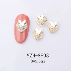Detailed view of 8x9.5mm heart butterfly nail art charms with pearls and gold alloy