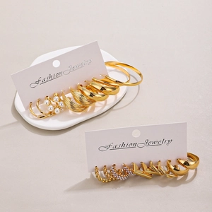 Detailed set of assorted gold-tone alloy earrings featuring hoops and pearl studs
