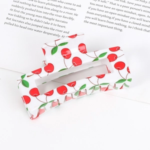 Rectangular white acrylic hair claw clip with vibrant red cherry and green leaf patterns