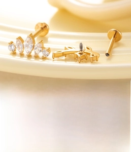 Macro shot of 1.2mm stainless steel labret stud with zircon heart crown and screw detail