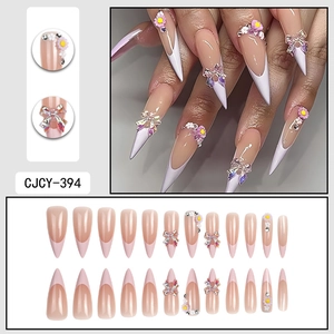 French purple press-on nails with 3D bows, daisies, and rhinestones in long almond shape