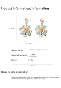 Detail view of oval drop earrings with floral diamond accents showing size 4.1cm x 2.4cm