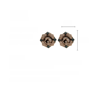 Detail shot of vintage flower stud earrings with teal enamel and sparkling rhinestones