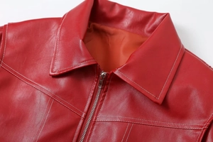 Detail of red leather biker jacket showing lapel design and metallic zipper hardware
