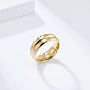 Detailed view of golden stainless steel ring featuring a brushed finish and center groove