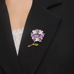 Broche élégante hortensia en émail violet avec cristaux sur une veste blazer noire