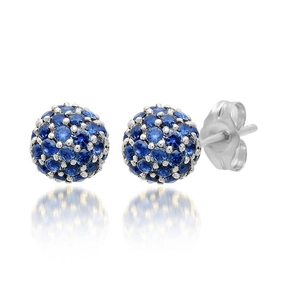 Close-up of blue sapphire pavé sphere stud earrings with silver metal settings