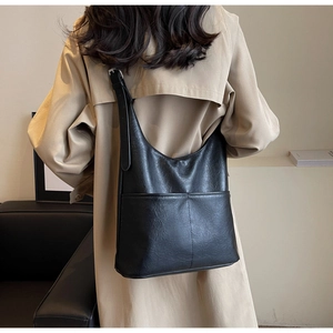 Detail of black large-capacity bucket bag showing natural silhouette and leather texture