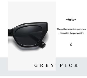 Close-up of black cat-eye sunglasses with polished frames and sharp geometric angles