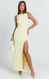 Detail of light yellow slim fit sleeveless dress showing high side slit and soft fabric
