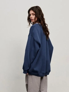 Side view of navy blue oversized drop-shoulder sweatshirt with minimalist silhouette