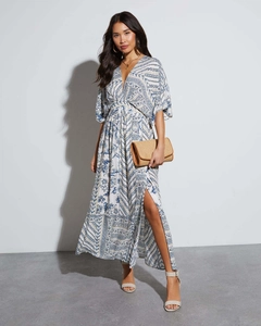 Detail of bohemian blue and white floral maxi dress with V-neck and high side slit