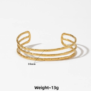 Detailed view of gold 16mm triple-layer wave cuff bracelet with hand-hammered texture