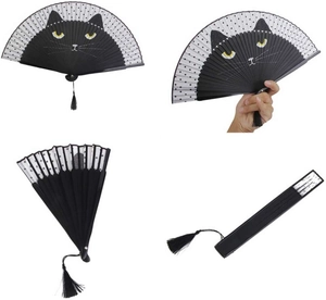 Detailed view of a black cat patterned folding fan with elegant black tassels and polka dots