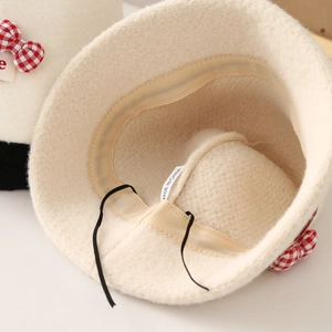 Detail view of lambswool bucket hat showing adjustable inner drawstring and sweatband