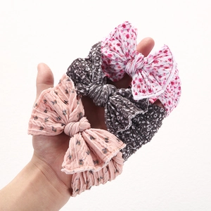 Three soft floral and polka dot print baby headbands with elegant nylon knots