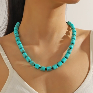 Detail of turquoise beaded necklace on model showing handmade ethnic vintage style