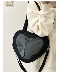 Fashionable heart-shaped ita bag in black with clear window for plush dolls on a model