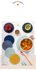 Detail of floral silicone placemats in multiple colors on a marble surface