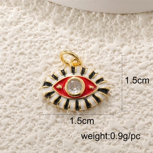 Macro shot of evil eye jewelry pendant with gold rim and dimension labels in cm