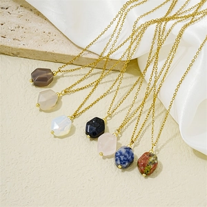 Minimalist gold chain necklace set with colorful hexagonal gemstone pendants on silk