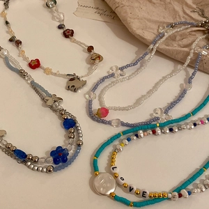 Set of five colorful seed bead necklaces with floral charms and irregular pearls