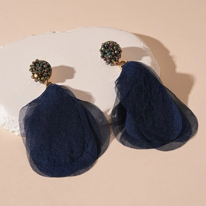 Detail of dark blue crystal beads and layered lace petal tassels on bohemian earrings