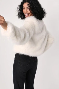 Detail view of the plush white faux fur coat back and soft fluffy texture for winter