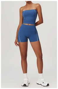 Detail of high-waisted royal blue yoga shorts with white contrast piping for women