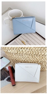 Detail view of compact zip wallets in blue and white with golden hardware accents