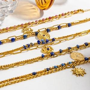 Lapis lazuli and quartz beaded bracelets in gold-plated steel featuring sun and heart charms