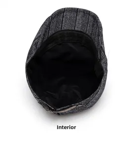 Internal view of grey newsboy cap showing soft black lining and premium leather trim