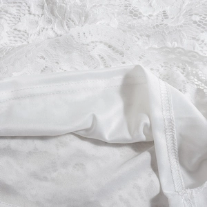 Close-up of white floral lace fabric with double-layer lining on a long backless dress