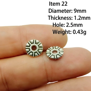 Macro view of a 9mm silver alloy spacer bead with radial pattern for DIY jewelry making