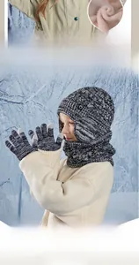 Detail of knit kids winter set with warm fleece lining and thick earflaps on snowy background