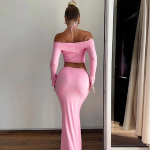 Pink knit two-piece set featuring off-shoulder long sleeve top and slim-fit maxi skirt