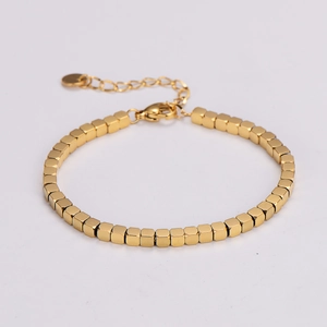 Close-up of golden square bead bracelet with adjustable lobster clasp on white background