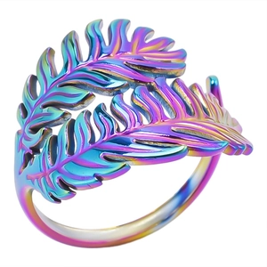 Macro shot of an adjustable leaf ring featuring a vibrant rainbow gradient metallic finish