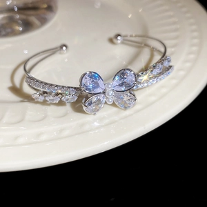 Close-up of butterfly zircon bracelet with sparkling wings and small pearl details