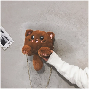 Detail of cute brown plush cat bag featuring pink ear accents and golden chain strap